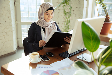 Image showing Portrait of a beautiful arabian businesswoman wearing hijab while working