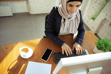 Image showing Portrait of a beautiful arabian businesswoman wearing hijab while working