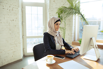 Image showing Portrait of a beautiful arabian businesswoman wearing hijab while working