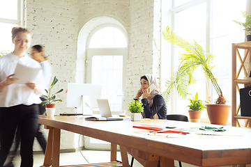 Image showing Portrait of a beautiful arabian businesswoman wearing hijab while working