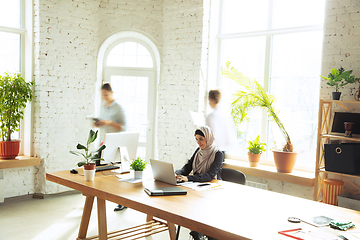 Image showing Portrait of a beautiful arabian businesswoman wearing hijab while working