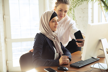 Image showing Portrait of a beautiful arabian businesswoman wearing hijab while working