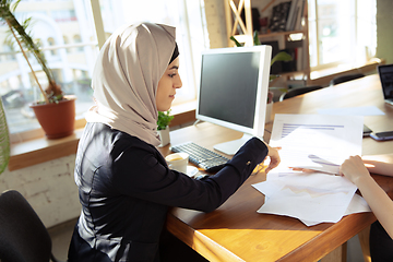 Image showing Portrait of a beautiful arabian businesswoman wearing hijab while working