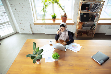 Image showing Portrait of a beautiful arabian businesswoman wearing hijab while working