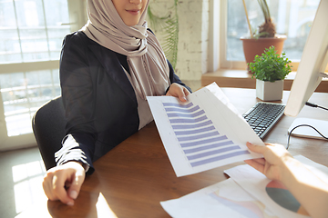 Image showing Portrait of a beautiful arabian businesswoman wearing hijab while working