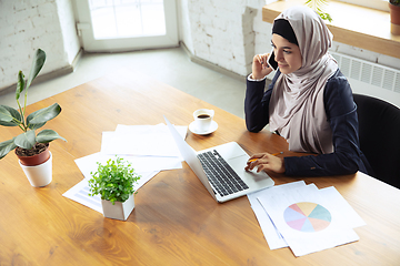 Image showing Portrait of a beautiful arabian businesswoman wearing hijab while working