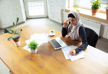 Image showing Portrait of a beautiful arabian businesswoman wearing hijab while working