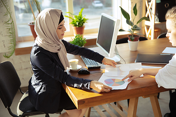 Image showing Portrait of a beautiful arabian businesswoman wearing hijab while working