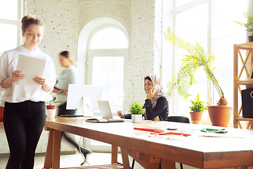 Image showing Portrait of a beautiful arabian businesswoman wearing hijab while working