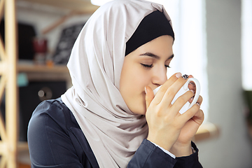 Image showing Portrait of a beautiful arabian businesswoman wearing hijab while working