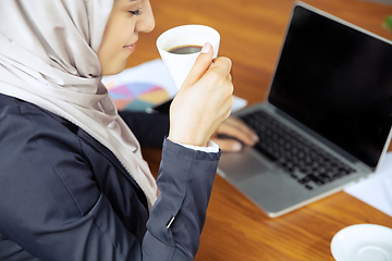 Image showing Portrait of a beautiful arabian businesswoman wearing hijab while working