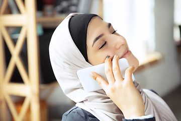 Image showing Portrait of a beautiful arabian businesswoman wearing hijab while working