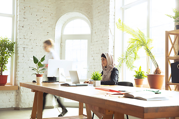 Image showing Portrait of a beautiful arabian businesswoman wearing hijab while working