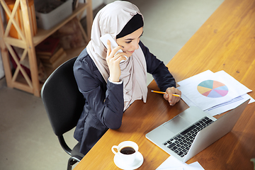 Image showing Portrait of a beautiful arabian businesswoman wearing hijab while working