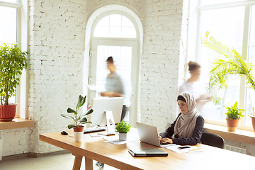 Image showing Portrait of a beautiful arabian businesswoman wearing hijab while working