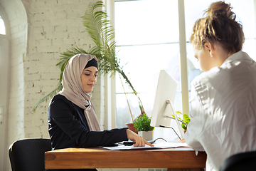 Image showing Portrait of a beautiful arabian businesswoman wearing hijab while working