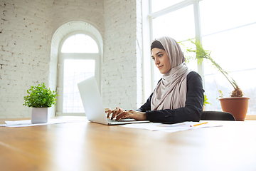 Image showing Portrait of a beautiful arabian businesswoman wearing hijab while working