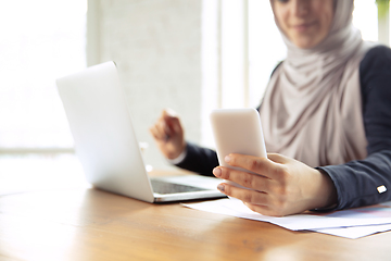 Image showing Portrait of a beautiful arabian businesswoman wearing hijab while working