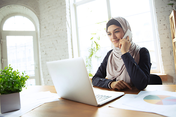 Image showing Portrait of a beautiful arabian businesswoman wearing hijab while working