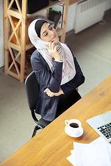 Image showing Portrait of a beautiful arabian businesswoman wearing hijab while working