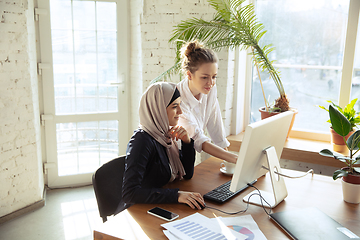 Image showing Portrait of a beautiful arabian businesswoman wearing hijab while working