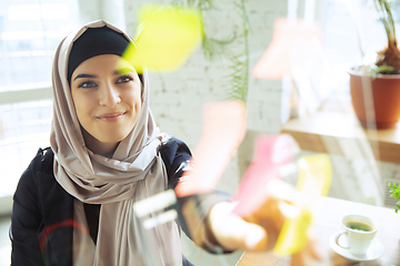 Image showing Portrait of a beautiful arabian businesswoman wearing hijab while working