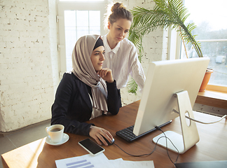 Image showing Portrait of a beautiful arabian businesswoman wearing hijab while working