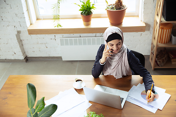 Image showing Portrait of a beautiful arabian businesswoman wearing hijab while working