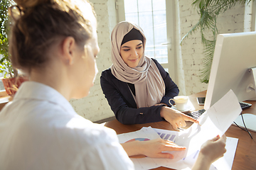 Image showing Portrait of a beautiful arabian businesswoman wearing hijab while working