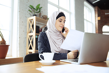 Image showing Portrait of a beautiful arabian businesswoman wearing hijab while working