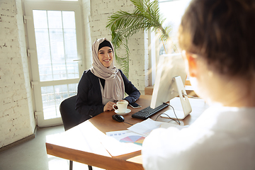 Image showing Portrait of a beautiful arabian businesswoman wearing hijab while working