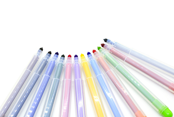 Image showing Open multicolored markers on a white background