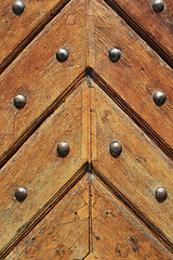 Image showing Closeup of old vintage wooden doors with metal rivets