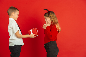 Image showing Valentine\'s day celebration, happy caucasian kids isolated on red background