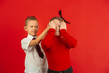 Image showing Valentine\'s day celebration, happy caucasian kids isolated on red background