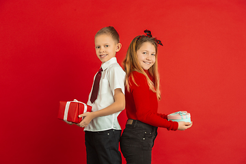 Image showing Valentine\'s day celebration, happy caucasian kids isolated on red background