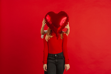 Image showing Valentine\'s day celebration, happy caucasian kids isolated on red background