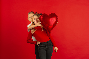 Image showing Valentine\'s day celebration, happy caucasian kids isolated on red background