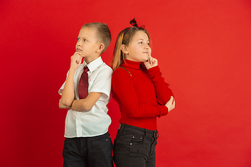 Image showing Valentine\'s day celebration, happy caucasian kids isolated on red background