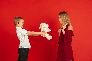 Image showing Valentine\'s day celebration, happy caucasian kids isolated on red background