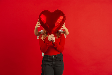 Image showing Valentine\'s day celebration, happy caucasian kids isolated on red background