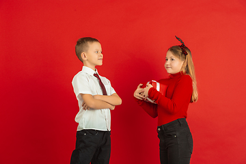 Image showing Valentine\'s day celebration, happy caucasian kids isolated on red background