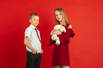 Image showing Valentine\'s day celebration, happy caucasian kids isolated on red background