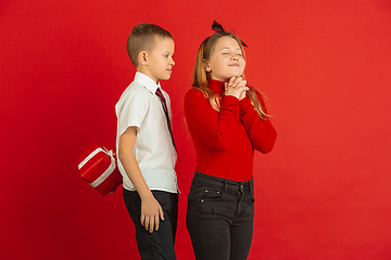 Image showing Valentine\'s day celebration, happy caucasian kids isolated on red background