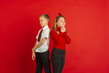 Image showing Valentine\'s day celebration, happy caucasian kids isolated on red background