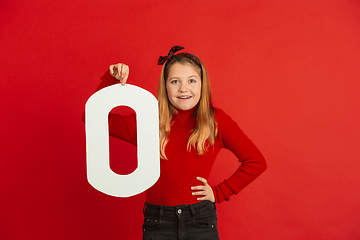 Image showing Valentine\'s day celebration, happy caucasian girl holding letter on red background