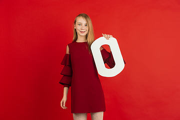 Image showing Valentine\'s day celebration, happy caucasian girl holding letter on red background