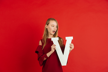 Image showing Valentine\'s day celebration, happy caucasian girl holding letter on red background