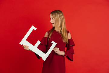 Image showing Valentine\'s day celebration, happy caucasian girl holding letter on red background