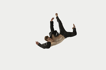 Image showing Man in casual style clothes jumping and dancing isolated on white background. Art, motion, action, flexibility, inspiration concept. Flexible caucasian ballet dancer.